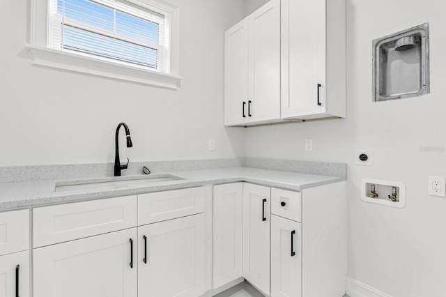 laundry room featuring cabinets, washer hookup, electric dryer hookup, and sink