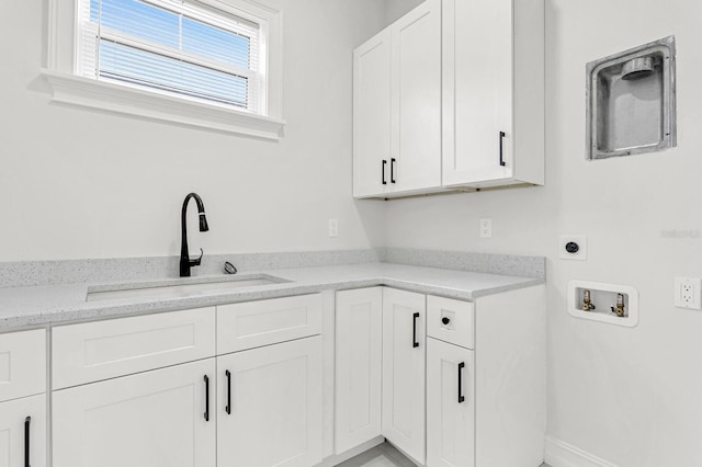 laundry room featuring a sink, hookup for a washing machine, cabinet space, and hookup for an electric dryer