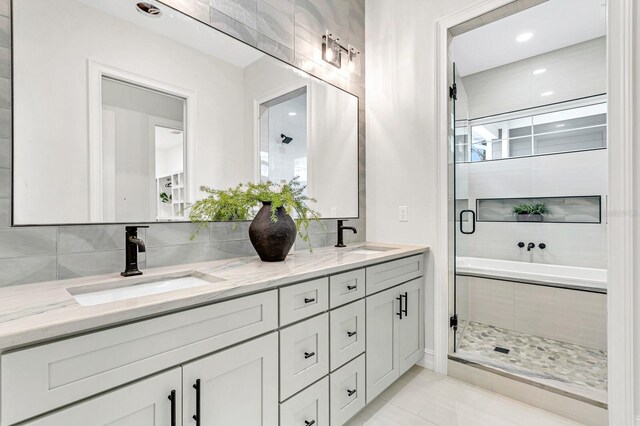 bathroom featuring vanity, tile patterned flooring, and plus walk in shower