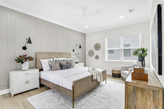 bedroom with light hardwood / wood-style floors and crown molding