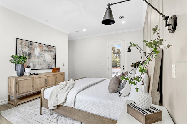 bedroom featuring access to exterior, crown molding, and light hardwood / wood-style flooring