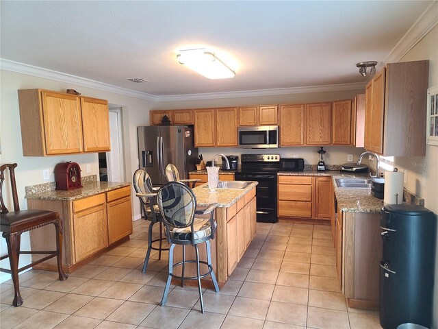 kitchen with light tile patterned floors, a center island, stainless steel appliances, sink, and a kitchen breakfast bar