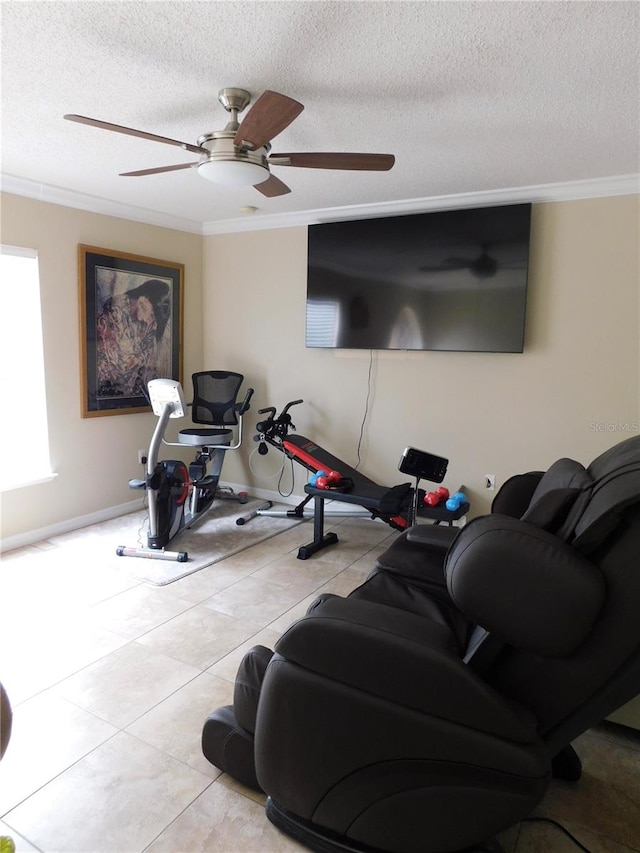 exercise area with ceiling fan, light tile patterned floors, a textured ceiling, and ornamental molding