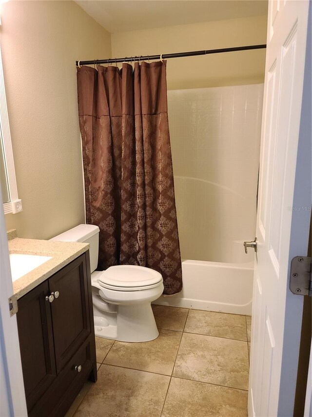 full bathroom with tile patterned flooring, vanity, toilet, and shower / bath combo