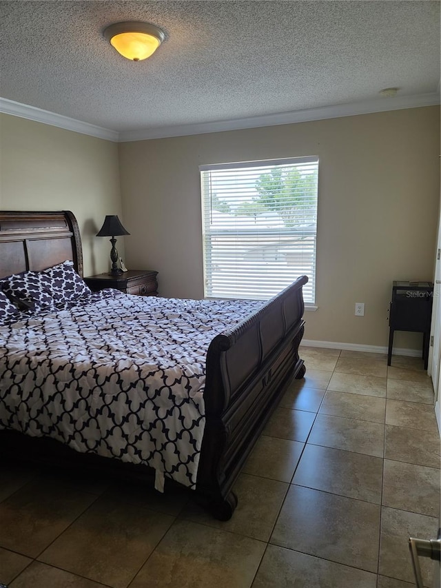 bedroom featuring a textured ceiling, ornamental molding, and tile patterned floors