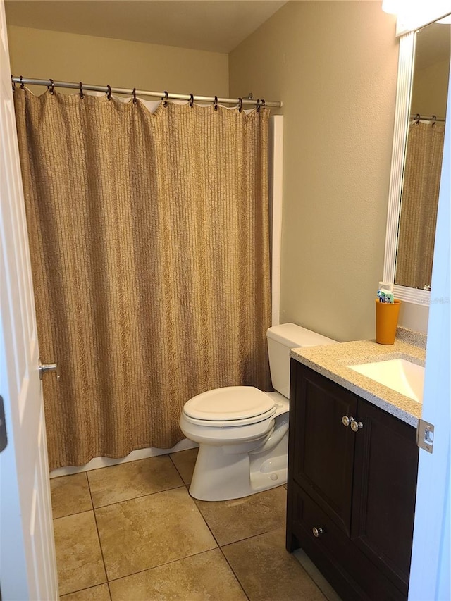 bathroom featuring vanity, toilet, curtained shower, and tile patterned flooring