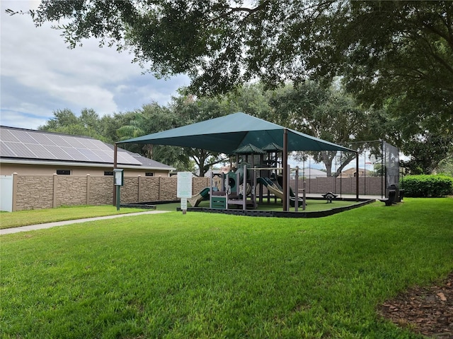 surrounding community featuring a playground and a lawn