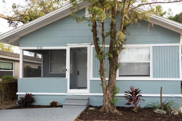 view of front of house featuring a sunroom