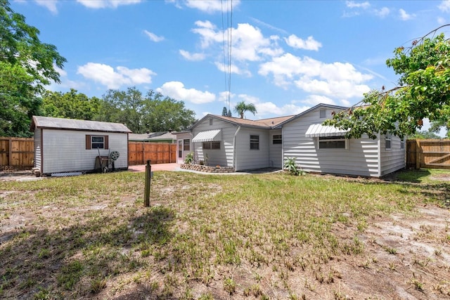 view of yard featuring a storage unit, an outdoor structure, and a fenced backyard