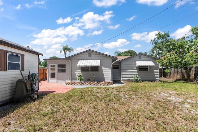 back of house with a patio area, fence, and a yard