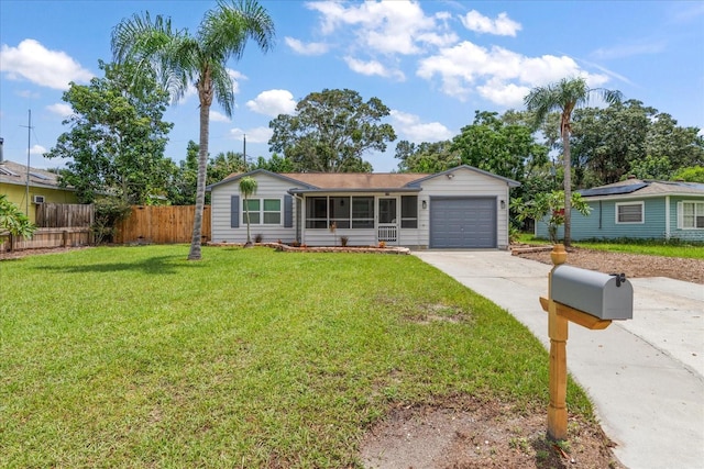 ranch-style house featuring driveway, an attached garage, fence, and a front lawn