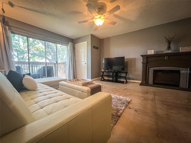 living room featuring ceiling fan and a textured ceiling