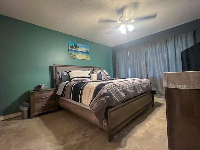 carpeted bedroom with ceiling fan and a textured ceiling