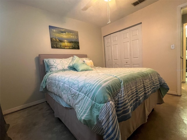 bedroom with concrete floors, a closet, and ceiling fan