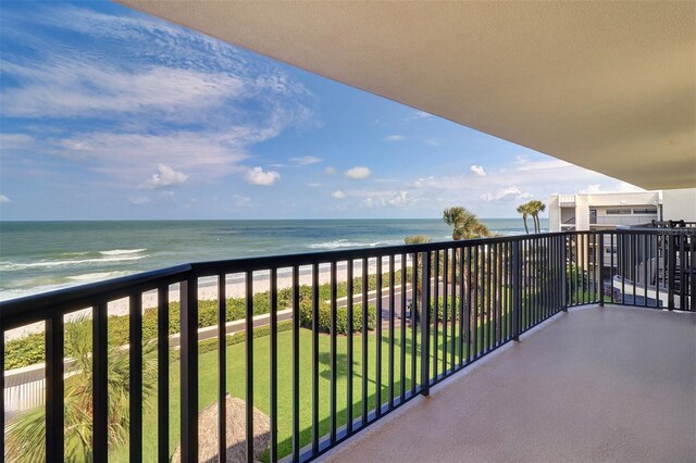 balcony featuring a water view and a beach view