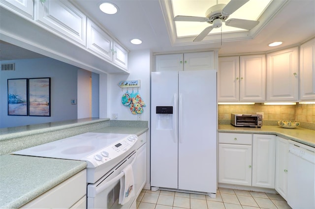 kitchen featuring white appliances, tasteful backsplash, light tile patterned floors, visible vents, and white cabinetry