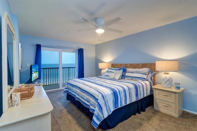 carpeted bedroom featuring access to exterior, ceiling fan, baseboards, and a textured ceiling