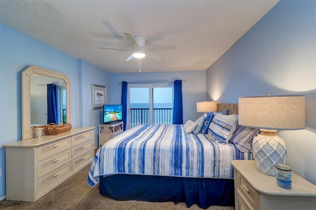 bedroom with access to exterior, a textured ceiling, a ceiling fan, and carpet flooring