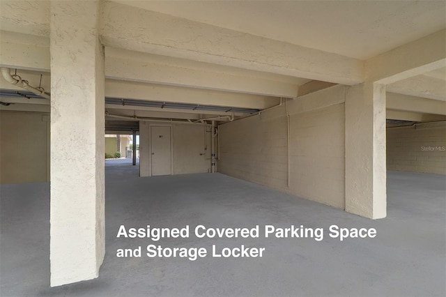 interior space with a garage and concrete block wall