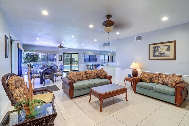 living area featuring light tile patterned floors, visible vents, a ceiling fan, and recessed lighting