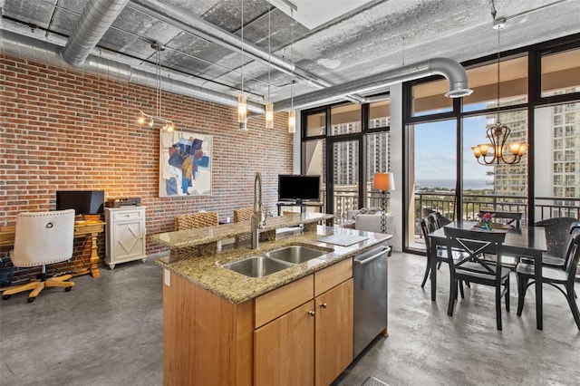 kitchen with brick wall, sink, hanging light fixtures, a notable chandelier, and stainless steel dishwasher