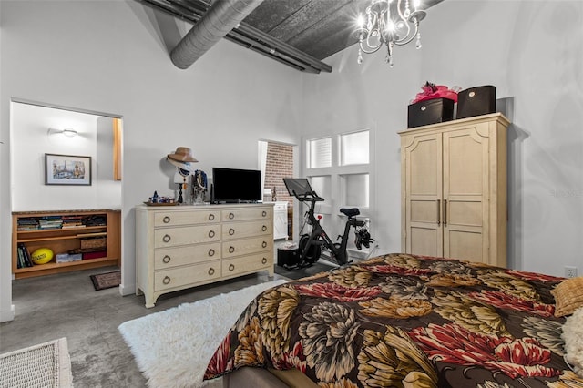 bedroom featuring a towering ceiling and an inviting chandelier