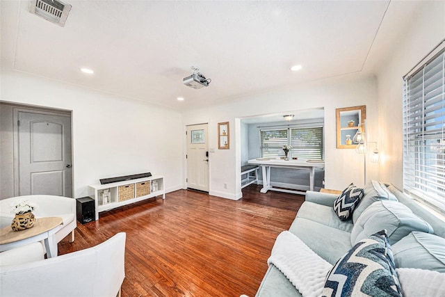 living room featuring baseboards, visible vents, dark wood-type flooring, and recessed lighting