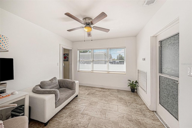 living room featuring ceiling fan, visible vents, and baseboards