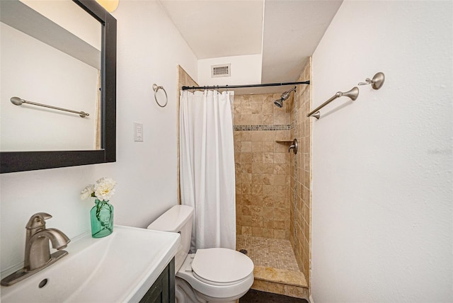 full bath with visible vents, a shower stall, toilet, and vanity