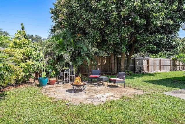 view of yard with an outdoor fire pit, a patio area, and a fenced backyard