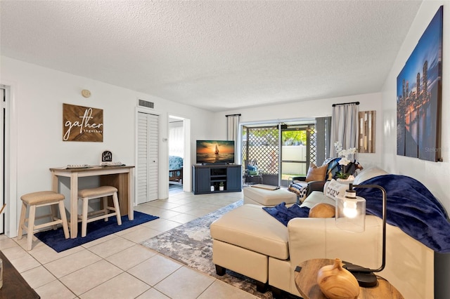 living room with light tile patterned floors and a textured ceiling