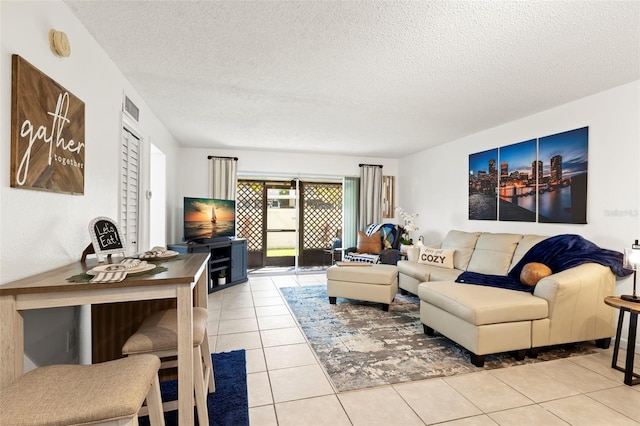 tiled living room featuring a textured ceiling