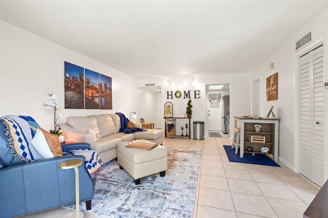 living room featuring tile patterned flooring and a textured ceiling