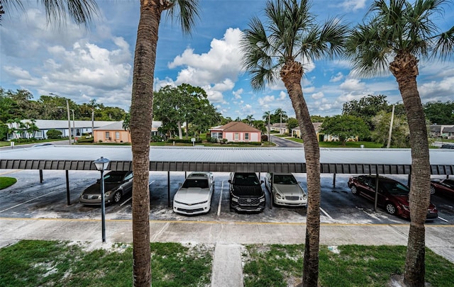 view of parking / parking lot with a carport