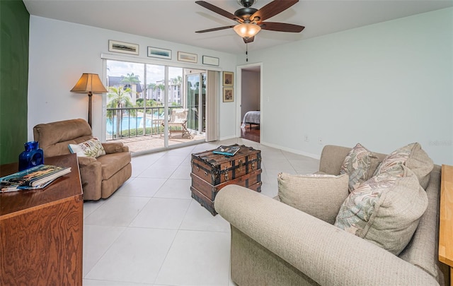 living room featuring ceiling fan and tile patterned flooring