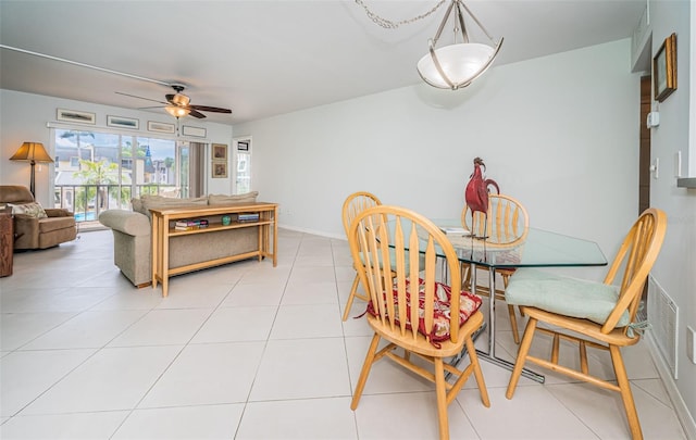 tiled dining space featuring ceiling fan