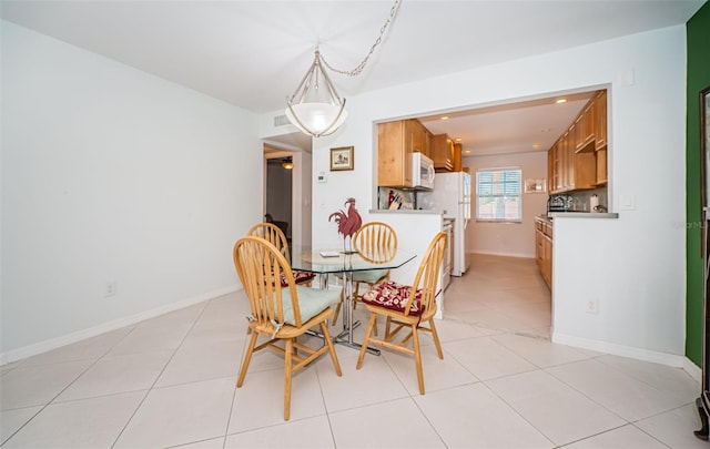 dining space featuring light tile patterned floors