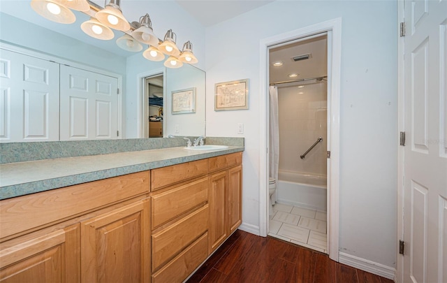 full bathroom featuring vanity, hardwood / wood-style floors, shower / tub combo with curtain, and toilet