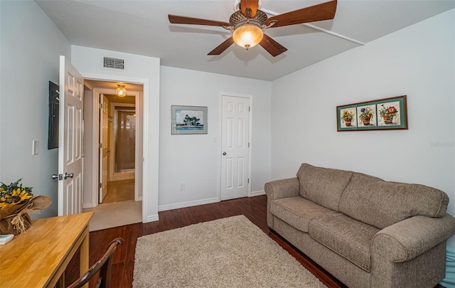 living room with ceiling fan and dark hardwood / wood-style flooring