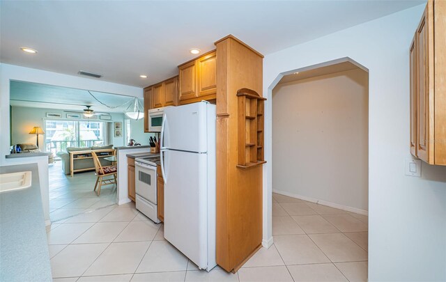 kitchen with white appliances, ceiling fan, and light tile patterned floors