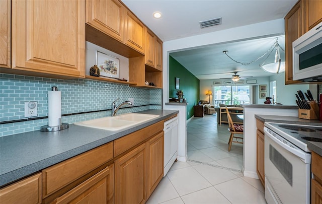 kitchen featuring ceiling fan, decorative backsplash, sink, light tile patterned flooring, and white appliances