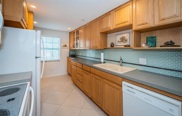 kitchen with light tile patterned flooring, backsplash, sink, and white appliances