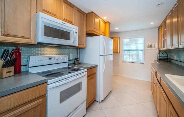 kitchen featuring backsplash, white appliances, and light tile patterned flooring