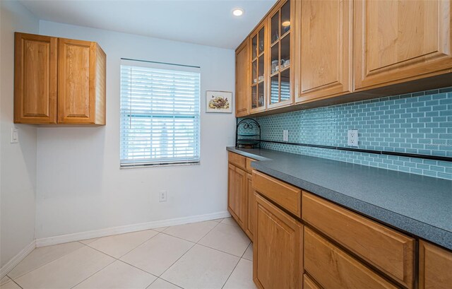 kitchen featuring tasteful backsplash and light tile patterned floors