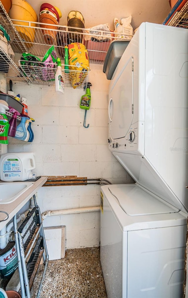 laundry room with stacked washing maching and dryer