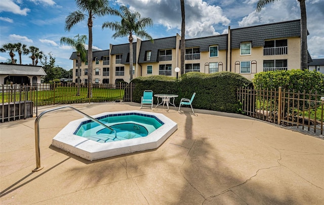 view of swimming pool featuring a patio area and a hot tub