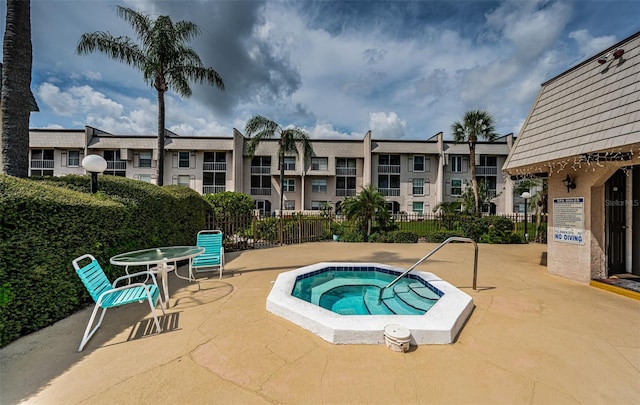 view of swimming pool featuring a patio area and a community hot tub