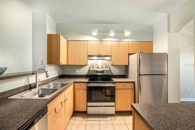 kitchen featuring appliances with stainless steel finishes, light brown cabinets, sink, and light tile patterned flooring