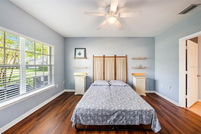 bedroom with ceiling fan and dark hardwood / wood-style flooring