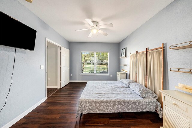 bedroom with ceiling fan and dark hardwood / wood-style floors